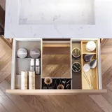 Bathroom inspiration with bathroom furniture in modern blue colour, elegant countertop basin and large square mirror with light, white herringbone tiles create a stylish and classic look