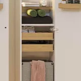 Large bathroom in green colors with vanity unit, brass framed oval mirror and beautiful framed doors