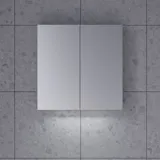 Large bathroom inspiration in Nordic style with bathroom furniture in light blue colour and wooden countertop with elegant countertop basin, herringbone wooden floor creating a bright and classic style