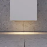 Large bathroom inspiration with grey vanity unit with integrated handle, stylish side-mounted sink, square mirror with rounded corners, concrete-look walls and raw materials for an urban look