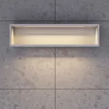 Stylish bathroom inspiration with beige vanity unit with inner drawer, upper cabinet, open shelf, oval mirror with lighting, matching pendants, shelf under the mirror, and wall-mounted toilet. Walls with light, elongated tiles