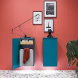 Large bathroom inspiration with blue special color grooved furniture, thin elegant sink, and beautiful round mirrors, red walls, and terrazzo floor create a strong contrast to the furniture, giving a stylish and urban look.