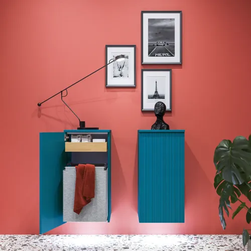 Large bathroom inspiration with blue special color grooved furniture, thin elegant sink, and beautiful round mirrors, red walls, and terrazzo floor create a strong contrast to the furniture, giving a stylish and urban look.