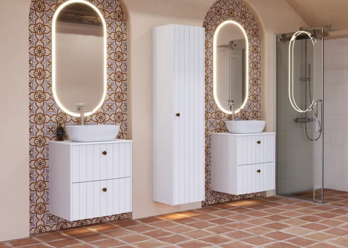 Large bathroom inspiration with white ribbed furniture, elegant countertops and countertop basins, oval mirrors with lights, exposed beams and patterned tiles create a vintage and stylish look