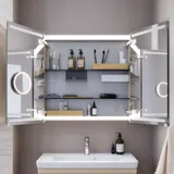 Small bathroom inspiration with a vanity unit and cabinet above the toilet in a beige custom color, elegant mirror cabinet with integrated lighting, the light colors and white curtain create a romantic and feminine atmosphere.
