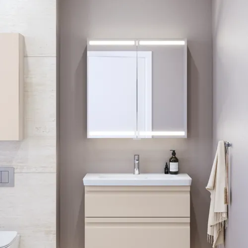 Small bathroom inspiration with a vanity unit and cabinet above the toilet in a beige custom color, elegant mirror cabinet with integrated lighting, the light colors and white curtain create a romantic and feminine atmosphere.