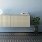 Bathroom with slanted ceiling inspiration, beige furniture with grooves, elegant countertop and square sink, beautiful mirror with shelves, blue walls, large windows, and black herringbone floor give a bright, urban look.