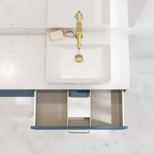Bathroom inspiration with bathroom furniture in modern blue colour, elegant countertop basin and large square mirror with light, white herringbone tiles create a stylish and classic look