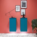 Large bathroom inspiration with blue special color grooved furniture, thin elegant sink, and beautiful round mirrors, red walls, and terrazzo floor create a strong contrast to the furniture, giving a stylish and urban look.