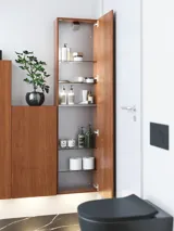 Modern and stylish bathroom inspiration with an oval mirror with a black frame and light control, colored toilet, vanity unit, base cabinets, and cabinets in reddish-brown oak, Silestone sink and matching floor