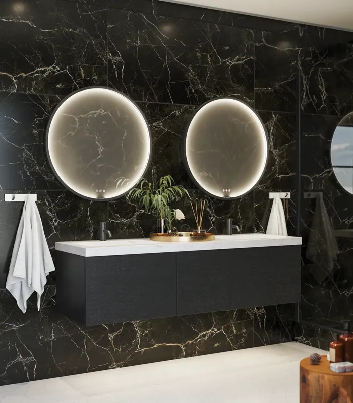 Elegant and modern bathroom inspiration with dark marble walls, round illuminated mirrors with black frames, wall-mounted vanity unit with double sinks, and a spacious shower area
