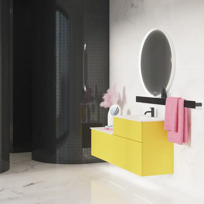 Large bathroom inspiration with a yellow vanity unit with an elegant white sink and countertop, stylish black shelf, and beautiful round mirror with white border, white marble walls and floor, and small black tiles give a modern and urban look.