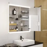 Large bathroom inspiration in a modern and minimalist style with white bathroom furniture and an elegant black countertop with square free-standing sinks, aesthetic and practical built-in mirror cabinets with light frame, and walk-in shower