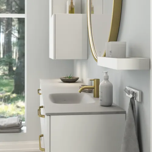 Large and romantic bathroom with brass framed round mirror