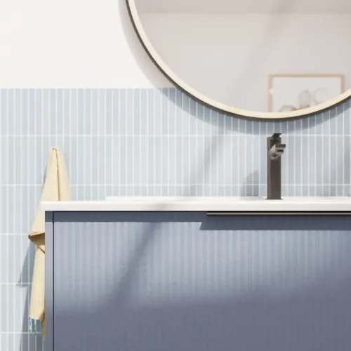 Bathroom inspiration with elongated light blue tiles and concrete floor, elegant light blue vanity with beautiful narrow stripes, sleek and thin sink, and a minimalist round mirror with a black edge and light, adding a touch of elegance to your bathroom.