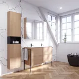 Bathroom inspiration with washbasin cabinets and wall cabinets in light oak with grooves, elegant double sink, beautiful mirror cabinet with light, herringbone floor in light wood, and white marble wall give a classic, bright, and sleek look.