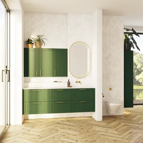 Large bathroom in green colors with vanity unit, brass framed oval mirror and beautiful framed doors