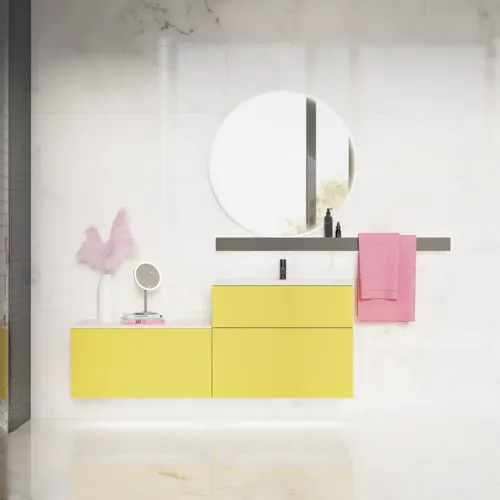 Large bathroom inspiration with a yellow vanity unit with an elegant white sink and countertop, stylish black shelf, and beautiful round mirror with white border, white marble walls and floor, and small black tiles give a modern and urban look.